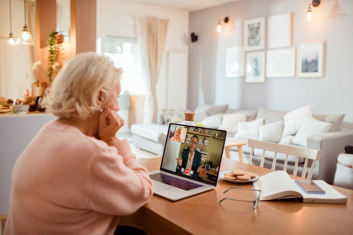 Older person at home on a telehealth video call with their nurse