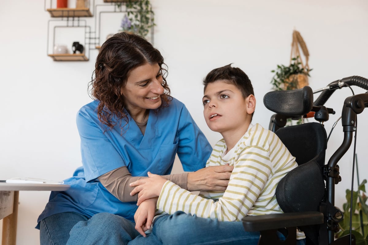 Tertiary Qualified Nurse Continence Specialist providing compassionate home care to a young NDIS participant