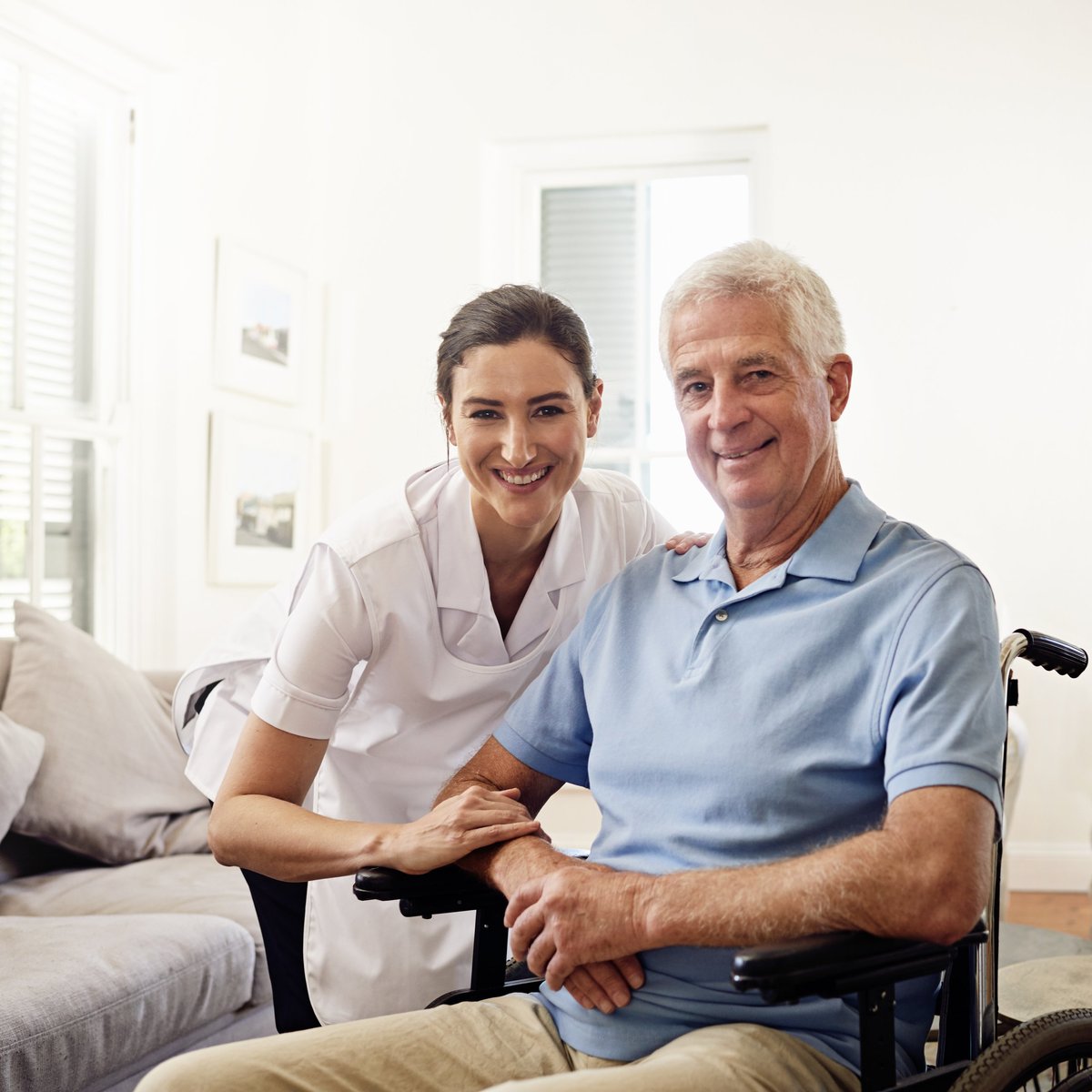 Carer supporting a disabled person in a wheelchair with compassionate, in-home care